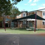 Green shade sail over playgroud