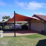 Red shade sail over car park