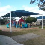 Green shade structure over playground