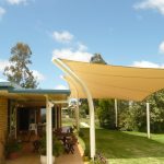 Cream Shade Sail near brick house Residential