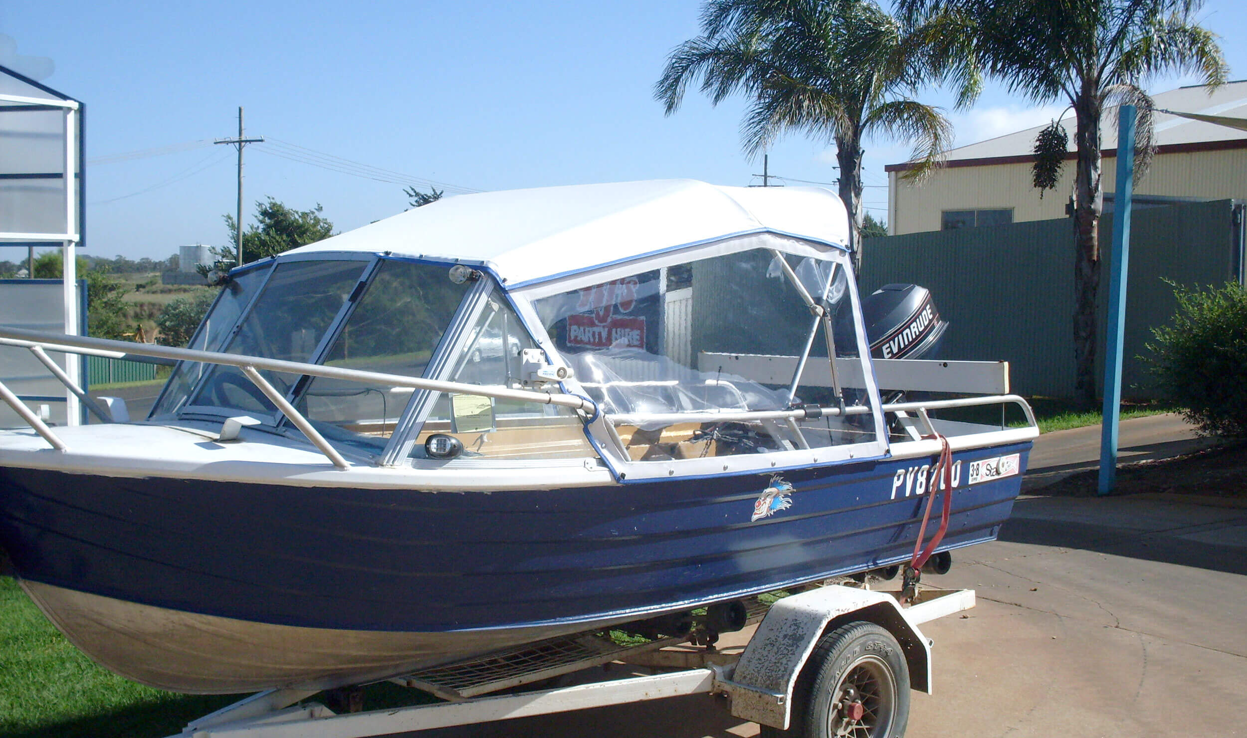 Blue and white boat with shade cover