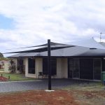 Black Shade Sail as Carport outside residential house